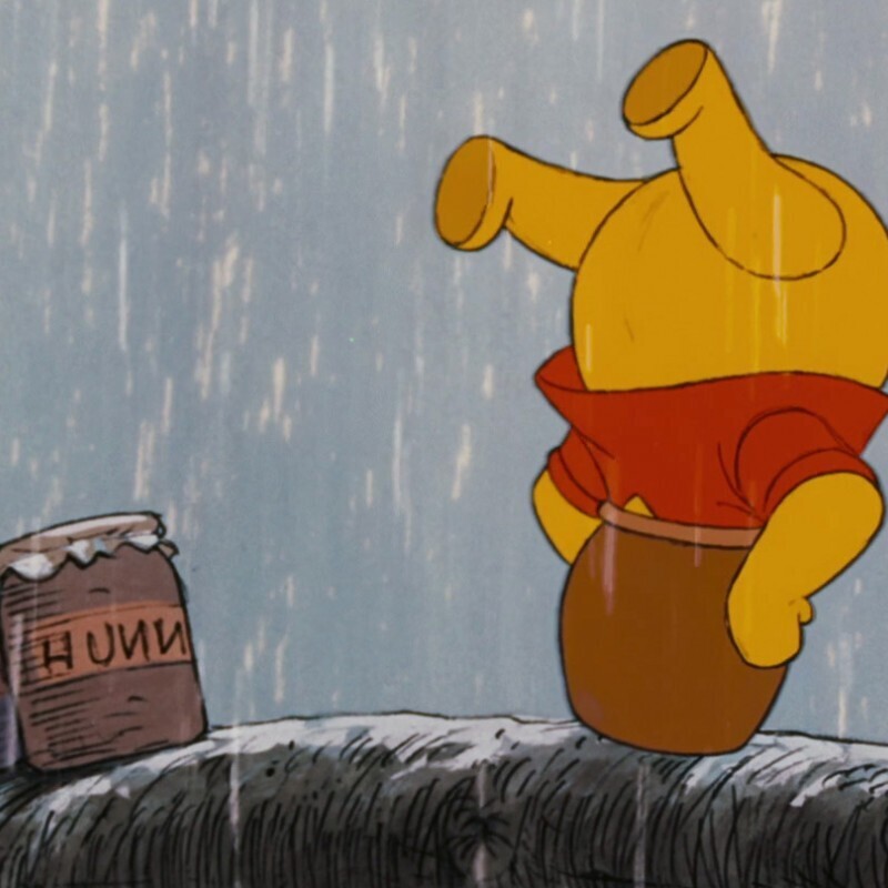 Winnie the pooh has his head stuck in his honey po
